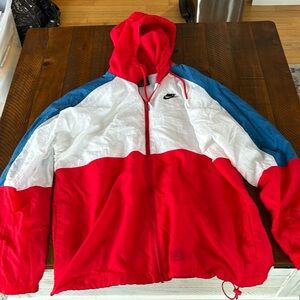 Nike men’s medium zip up hooded windbreaker. Red, white, and blue.